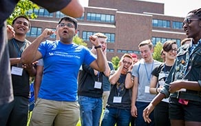 Several Honors students standing outside Capen Hall. smiling and laughing. 