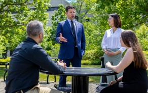 Dean Marcelo Araujo speaks with students on the Harriman Quad outside Squire Hall. 