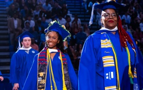 Students walking into a commencement ceremony. 