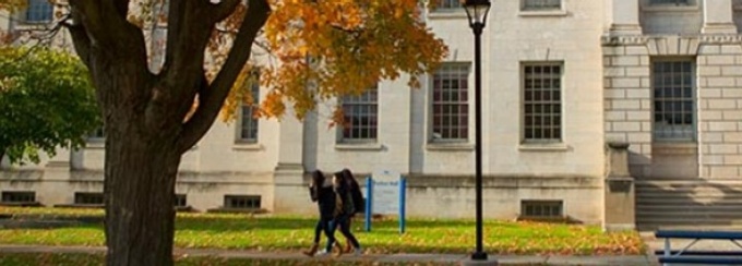Students walking in form of Parker Hall on UB's South Campus in the fall. 